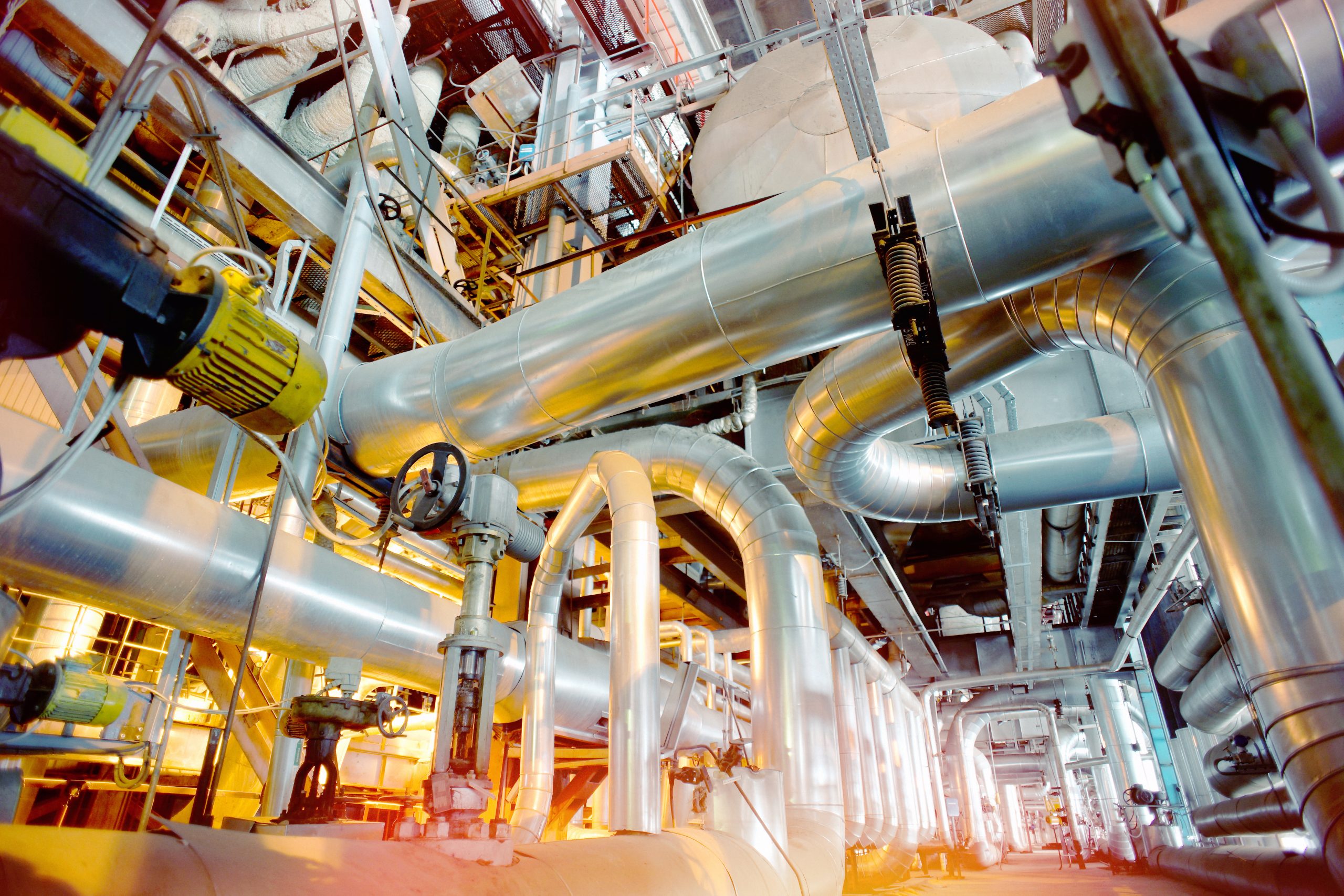Equipment, cables and piping as found inside of a modern industrial power plant